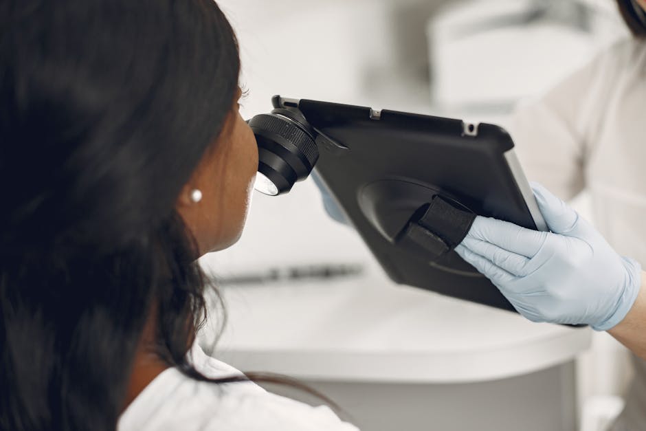 Dermatologist examining a patient with a digital dermatoscope for skin cancer screening