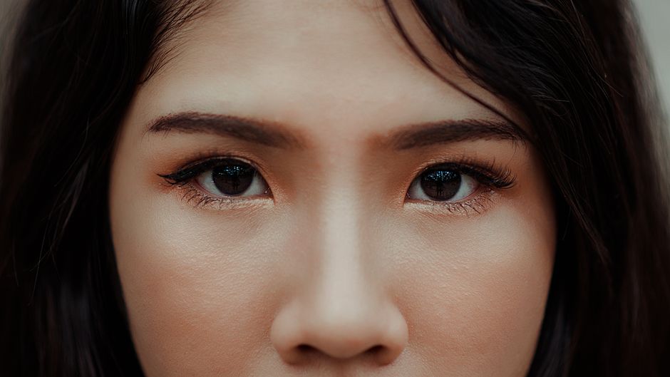 Close-up of a person's face with clear, healthy-looking skin in natural light